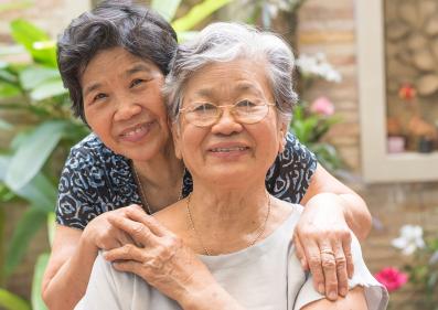 Portrait of Asian female older ageing women smiling with happiness in a garden