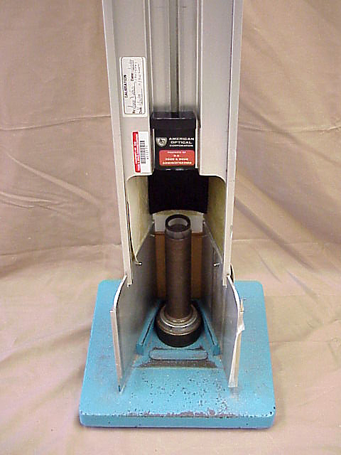 Figure 3.  The figure shows that the drop ball impact test shall be conducted with the lens supported by a tube (1-inch inside diameter, 11/4-inch outside diameter, and approximately 1-inch high) affixed to a rigid iron or steel base plate.