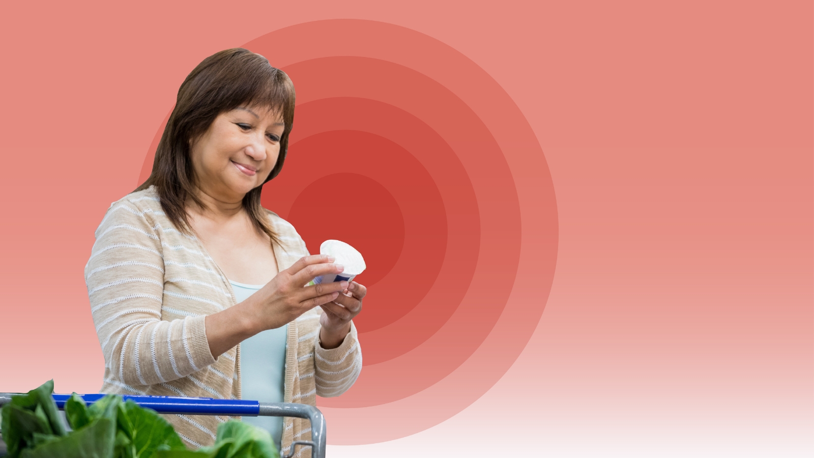 Image of middle age woman reading a fod label in a grocery store