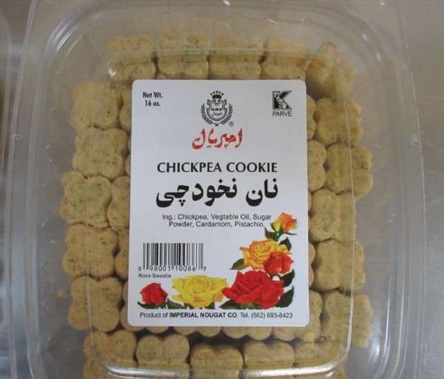 A clear plastic container of Imperial Nougat Co. Chickpea Cookies (نان نخودچی), net weight 16 oz. The label lists ingredients as chickpea, vegetable oil, sugar powder, cardamom, and pistachio. The label includes Persian script, a kosher (K Parve) certification symbol, a barcode, and decorative rose illustrations. The product is labeled "Rose Sweetie" and manufactured by Imperial Nougat Co., Tel. (562) 693-8423.