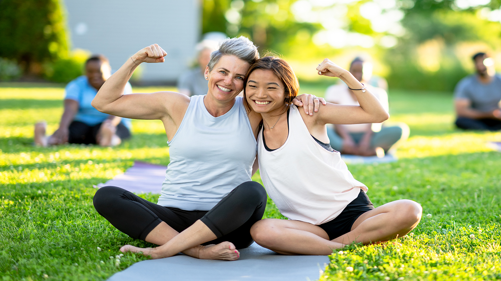 Middle aged and younger woman exercising outside