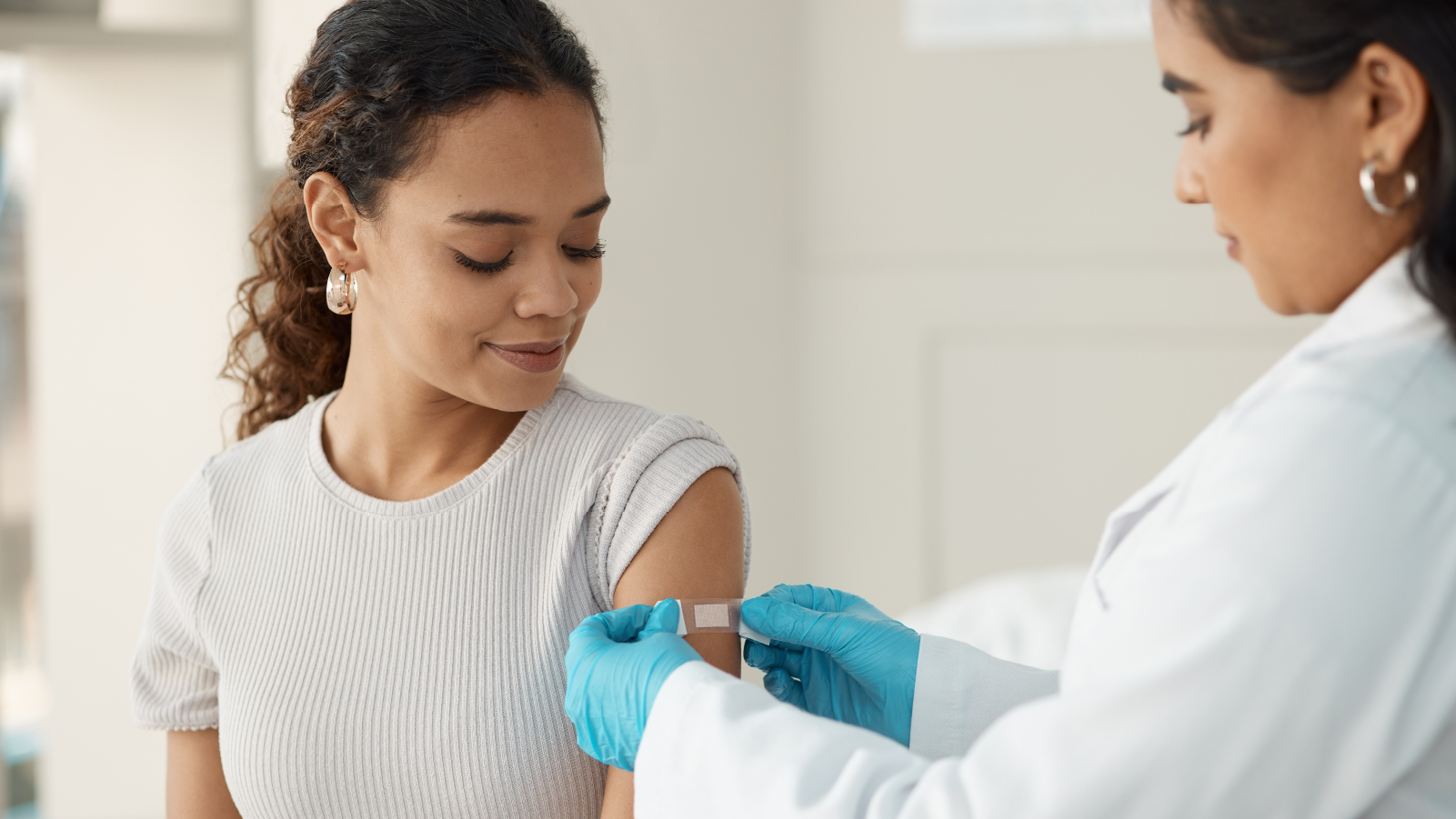 Woman receiving vaccine from HCP