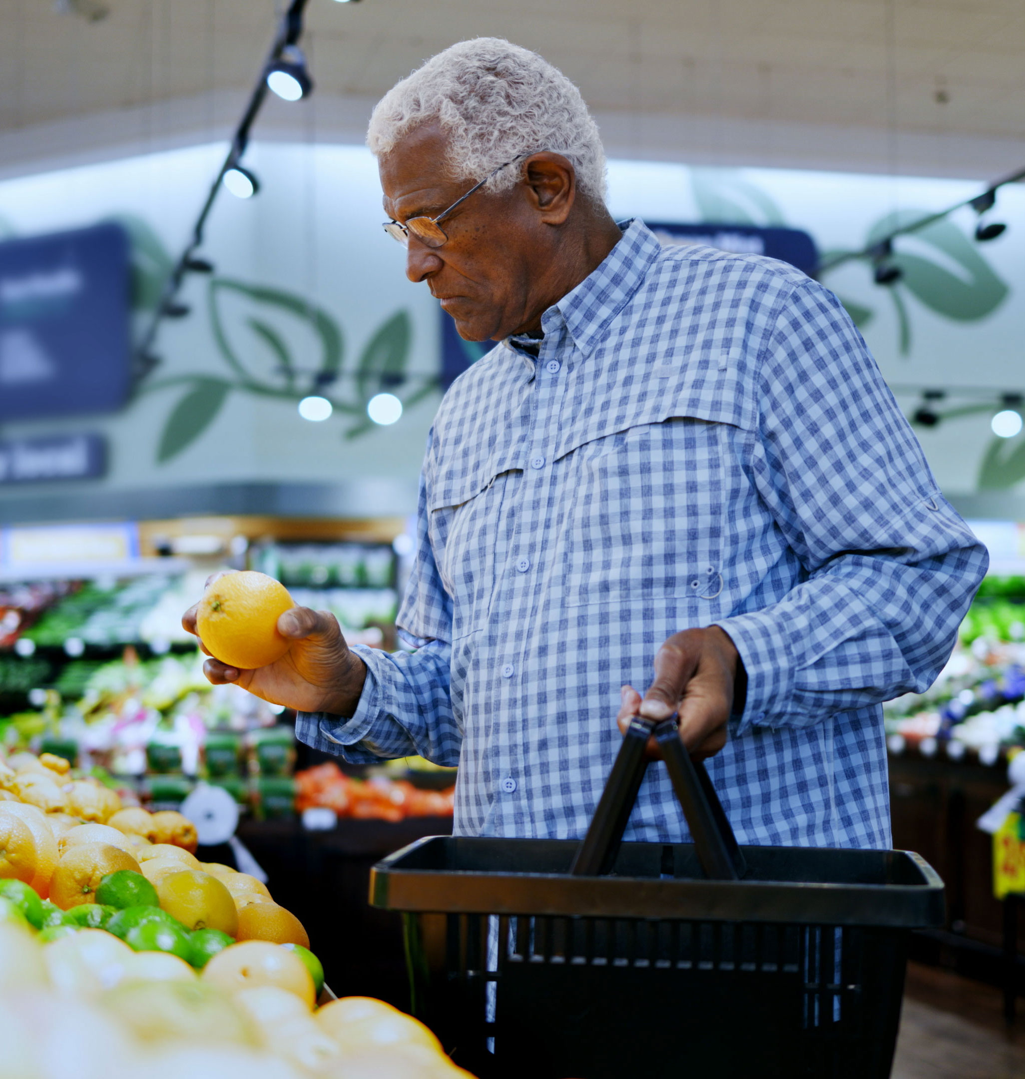 Man looking at produce in grocery store
