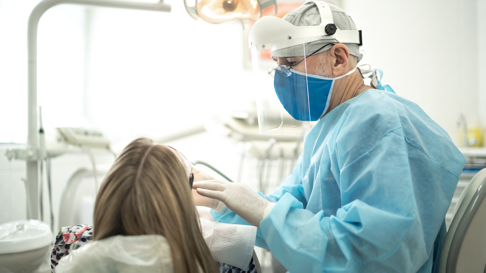 Photo of a dentist examining a patient