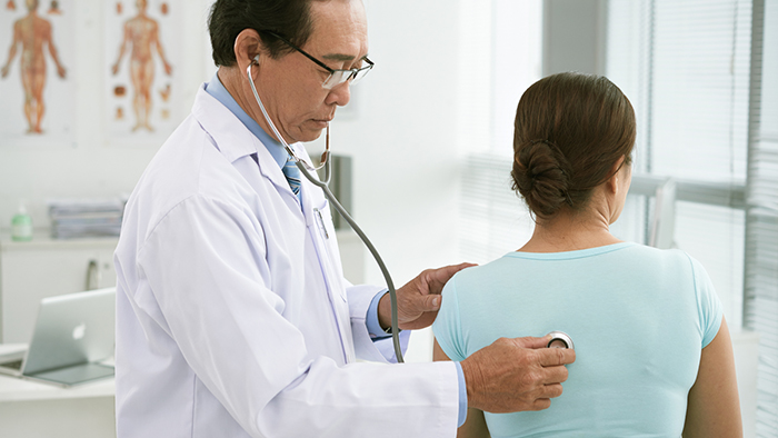 Doctor checking a patient's breathing