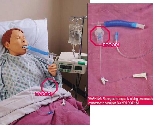 Tubing erroneously connected to nebulizer on mannequin in in hospital bed