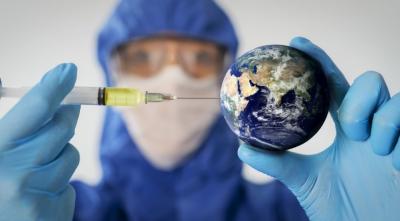 person in protective gear injecting a small globe 