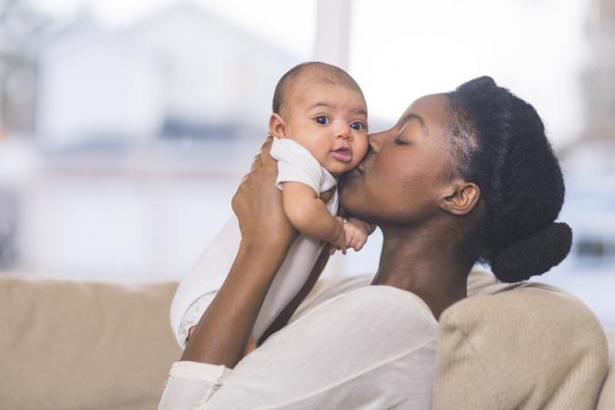African American mom kissing baby.jpg