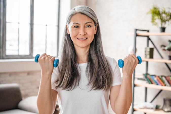 Middle-aged woman exercising with dumbbells
