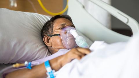 Patient in hospital bed on a ventilator