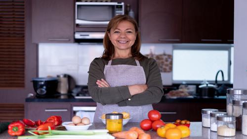 Latin American woman at home preparing a meal