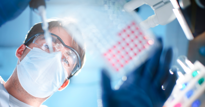 Image of lab technician placing samples onto tray.