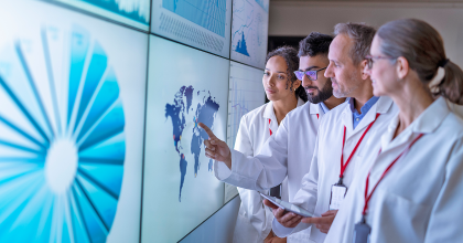 Scientists collaborating using a white board, illustrating alternative methods partnerships