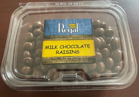 Image 1 – Top of container, Regal Gourmet Snack Brand Milk Chocolate Raisins in a plastic clamshell 