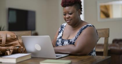 AA woman working on laptop